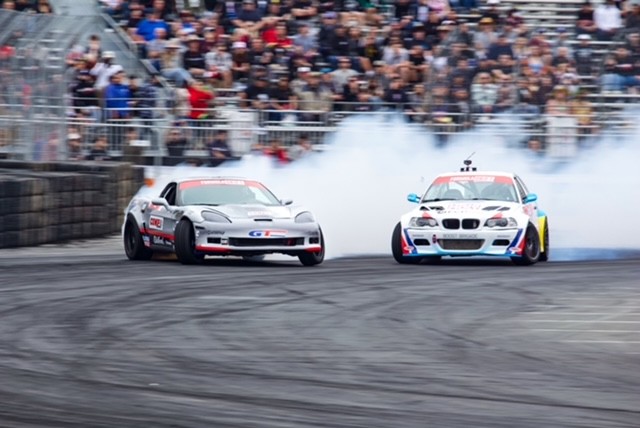 drift racecars sliding next to each other